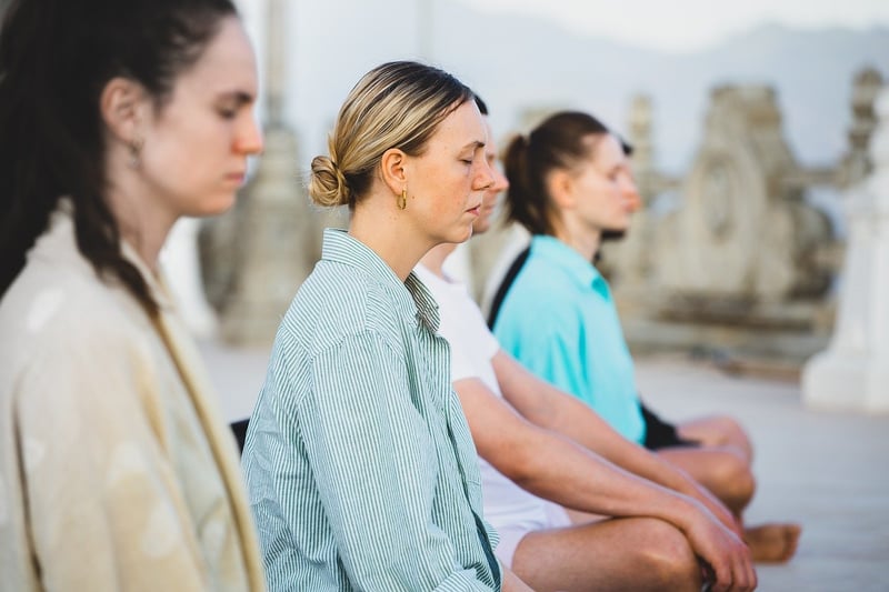 Silhouette of women meditating